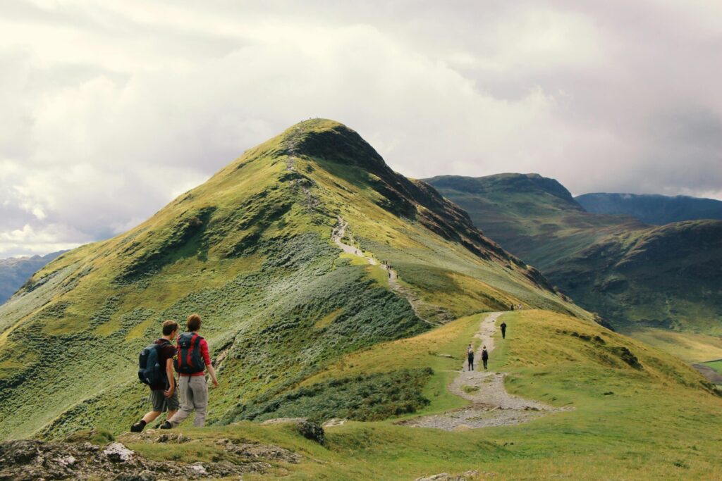 people on a mountain ridge, trail